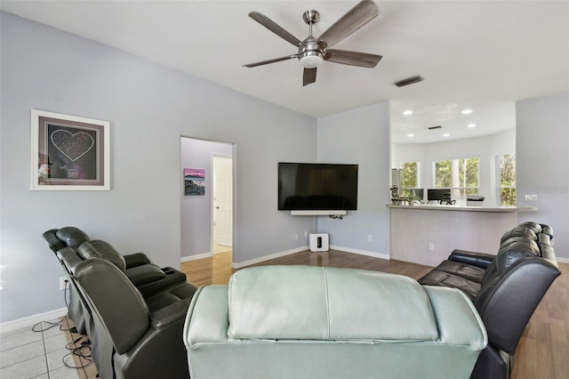 living room featuring light wood-type flooring and ceiling fan