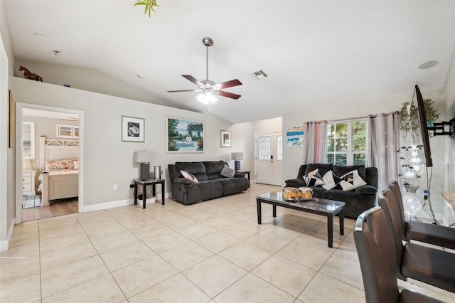 living room featuring ceiling fan, light tile patterned flooring, and lofted ceiling