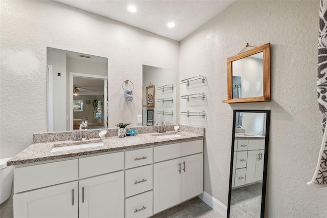 bathroom featuring ceiling fan and vanity