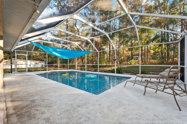 view of pool with a patio area and a lanai