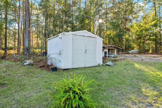 view of outdoor structure featuring a lawn