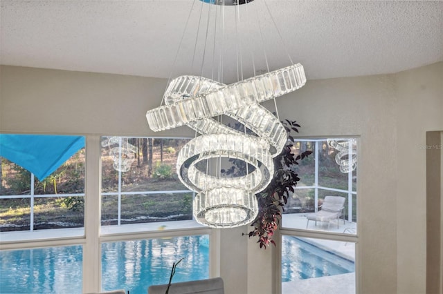 room details with a textured ceiling and a notable chandelier