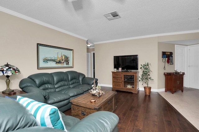 living room featuring dark hardwood / wood-style floors, ornamental molding, and a textured ceiling