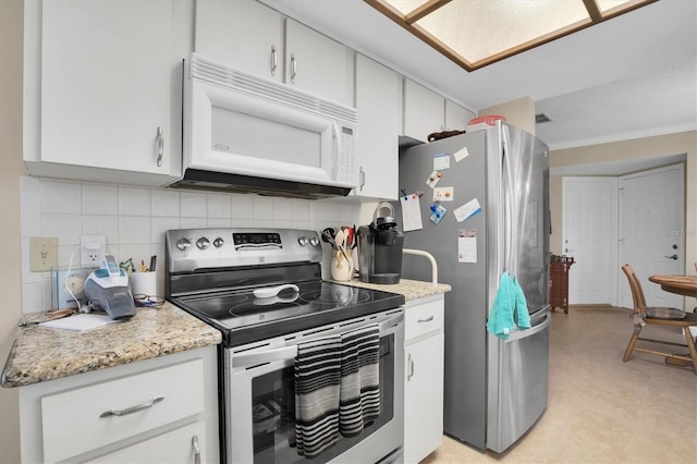 kitchen with white cabinetry, stainless steel appliances, and tasteful backsplash