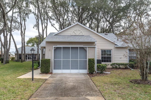 ranch-style house with stucco siding, a shingled roof, an attached garage, driveway, and a front lawn