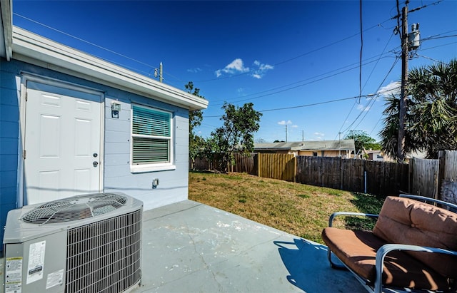 view of patio / terrace featuring cooling unit and fence