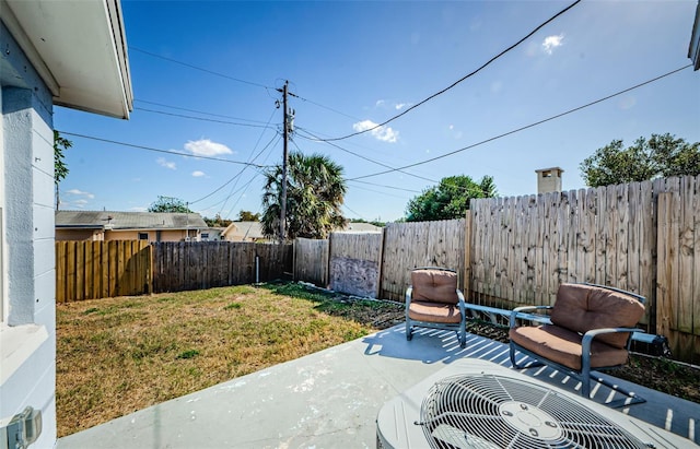 view of yard featuring central AC unit, a patio, and a fenced backyard