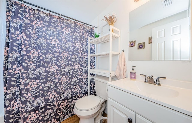 bathroom with visible vents, curtained shower, toilet, and vanity