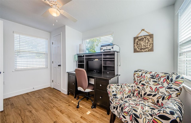 office space featuring light wood-style flooring, baseboards, and a ceiling fan