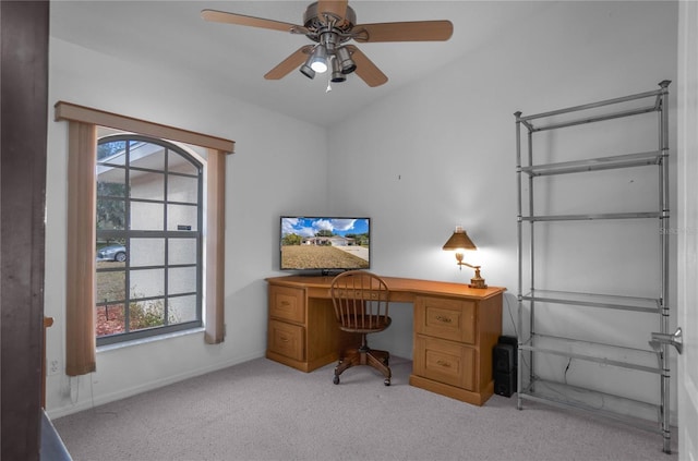 carpeted home office featuring ceiling fan