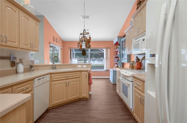 kitchen with pendant lighting, white appliances, dark wood-type flooring, vaulted ceiling, and light brown cabinetry