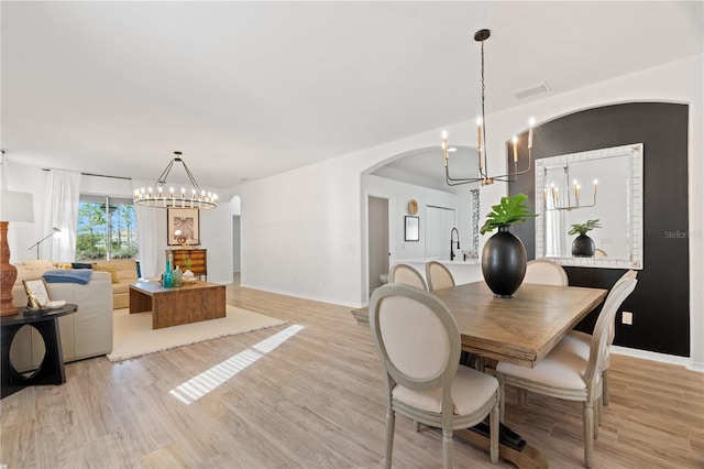 dining room featuring light wood-type flooring and sink