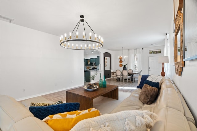 living room featuring light hardwood / wood-style floors and an inviting chandelier