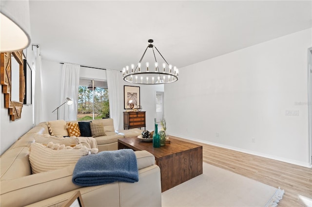 living room featuring light hardwood / wood-style floors and a notable chandelier