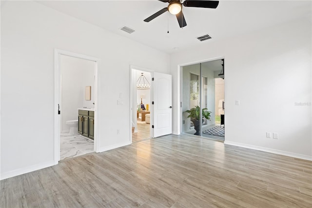 unfurnished bedroom featuring ensuite bath, ceiling fan, light hardwood / wood-style floors, and access to exterior