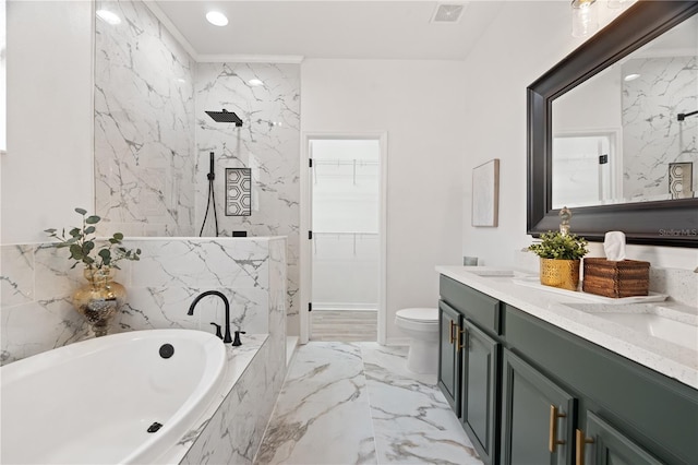 bathroom featuring vanity, a relaxing tiled tub, and toilet