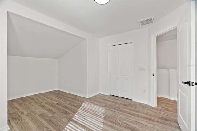 additional living space with light hardwood / wood-style flooring