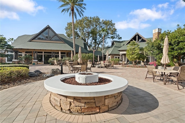 surrounding community featuring a patio area and an outdoor fire pit