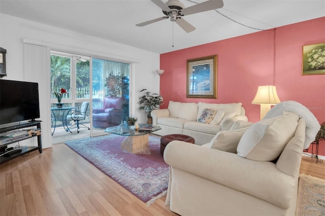 living room with hardwood / wood-style floors and ceiling fan