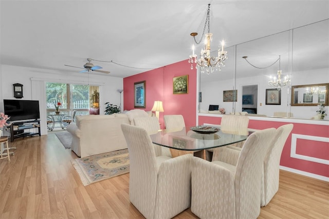 dining space featuring ceiling fan with notable chandelier and light hardwood / wood-style flooring