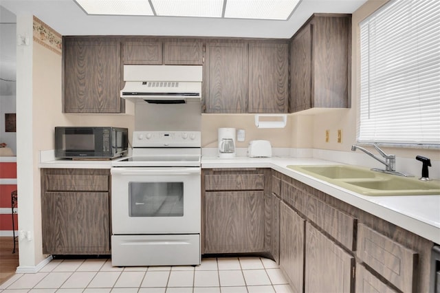 kitchen featuring ventilation hood, sink, light tile patterned floors, and white electric range