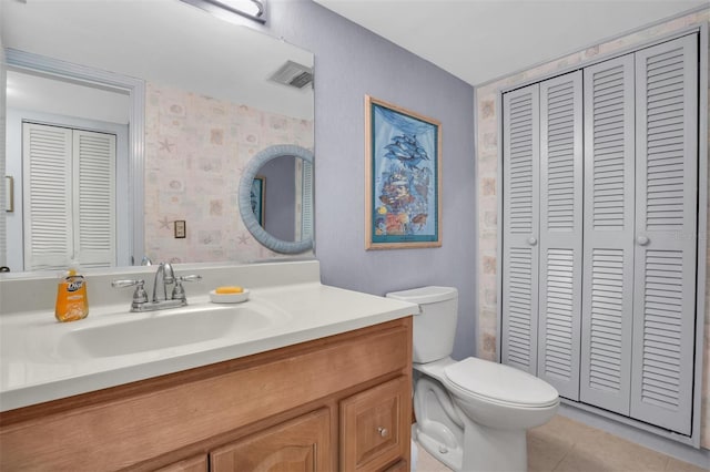 bathroom with tile patterned floors, vanity, and toilet