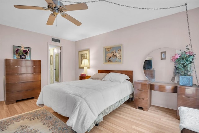 bedroom featuring ensuite bath, ceiling fan, and light hardwood / wood-style floors