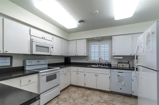 kitchen with white cabinetry, sink, light tile patterned floors, and white appliances