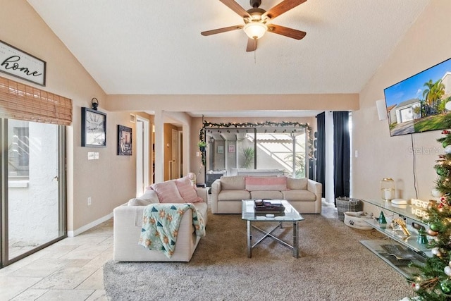 living room with a textured ceiling, ceiling fan, and vaulted ceiling