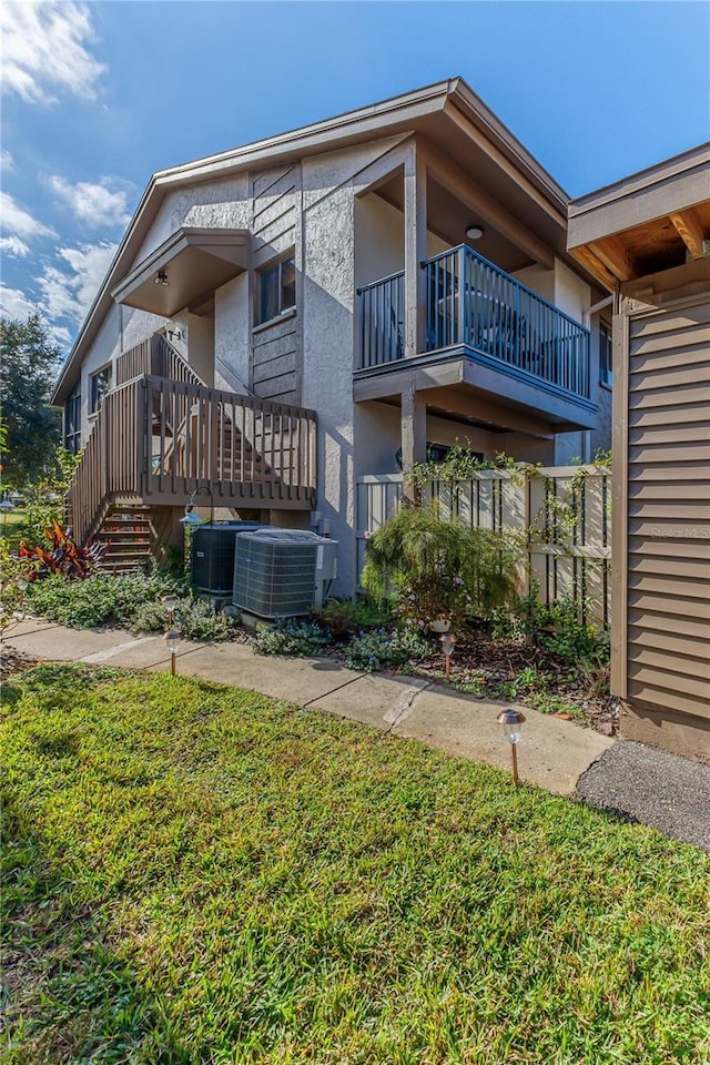 12814 Wedgewood Way Unit C, Hudson, FL 34667 - view of home's exterior with stucco siding and a yard