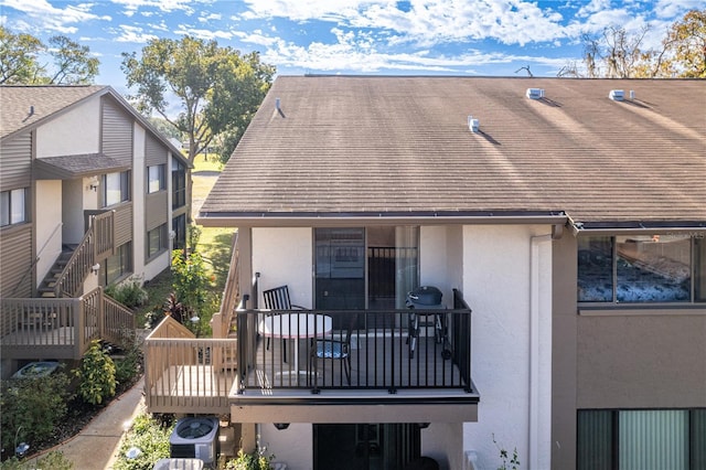 12814 Wedgewood Way Unit C, Hudson, FL 34667 - rear view of house with stucco siding and a shingled roof