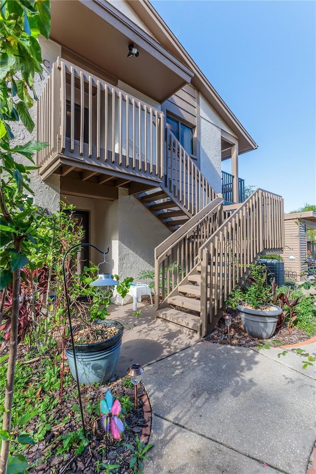 12814 Wedgewood Way Unit C, Hudson, FL 34667 - view of home's exterior featuring stucco siding, a patio area, and stairs