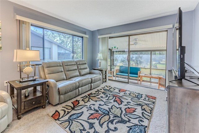 living room featuring carpet flooring and ceiling fan