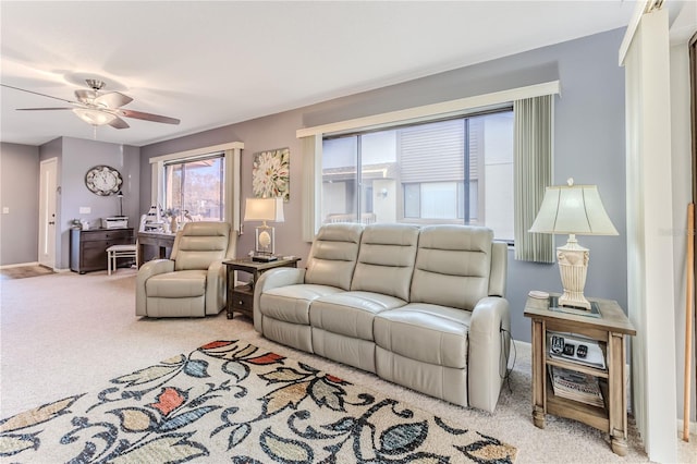 carpeted living room featuring ceiling fan