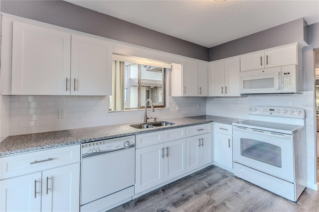 kitchen featuring white cabinets, white appliances, and sink