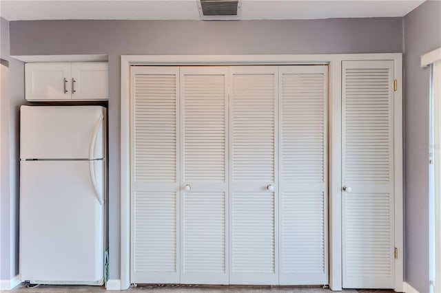 12814 Wedgewood Way Unit C, Hudson, FL 34667 - kitchen view of freestanding refrigerator and white cabinets