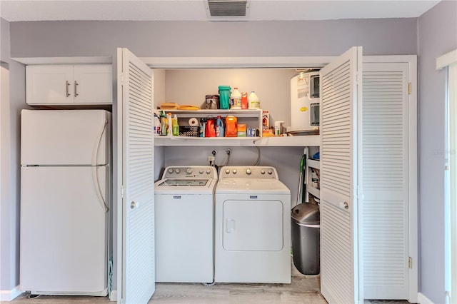 laundry area featuring independent washer and dryer and light wood-type flooring