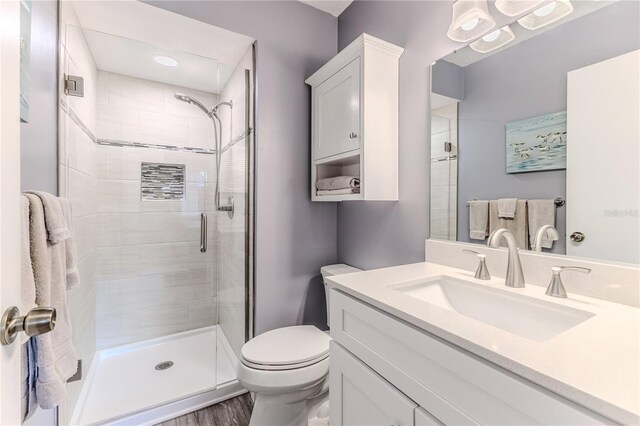 12814 Wedgewood Way Unit C, Hudson, FL 34667 - bathroom featuring vanity, a shower stall, and wood finished floors