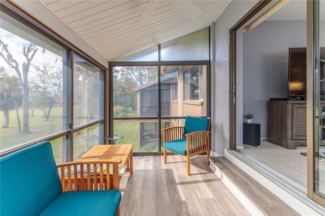 sunroom featuring plenty of natural light and vaulted ceiling