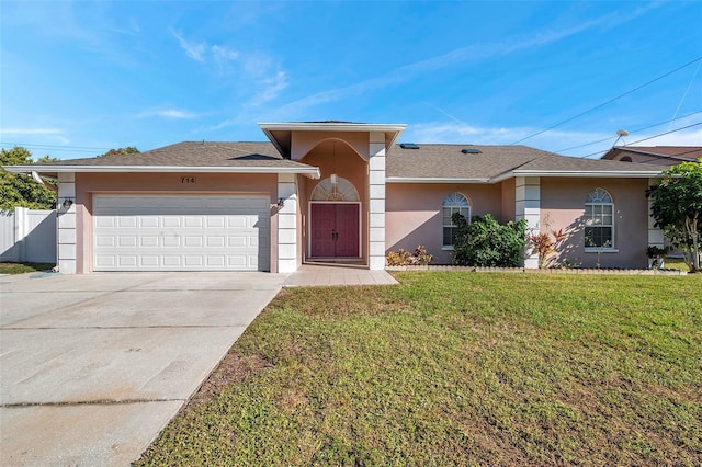 ranch-style home with a front yard and a garage