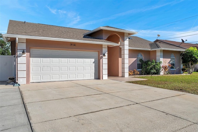 view of front of home with a front lawn and a garage