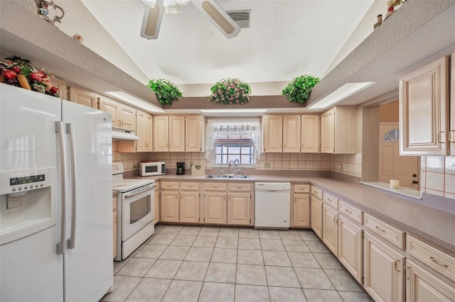 kitchen with white appliances, sink, vaulted ceiling, decorative backsplash, and light tile patterned floors