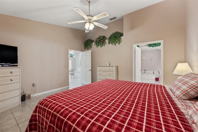 bedroom featuring ceiling fan, light tile patterned floors, a high ceiling, and ensuite bath