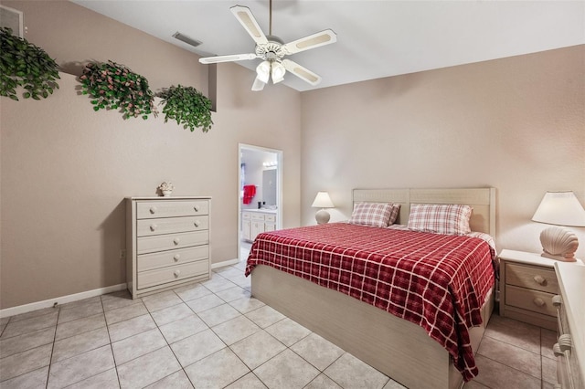 bedroom featuring ensuite bathroom, ceiling fan, and light tile patterned floors