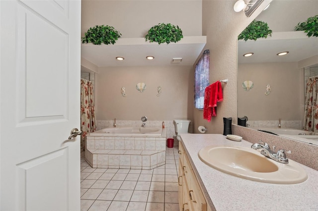 bathroom with tiled bath, tile patterned flooring, and vanity