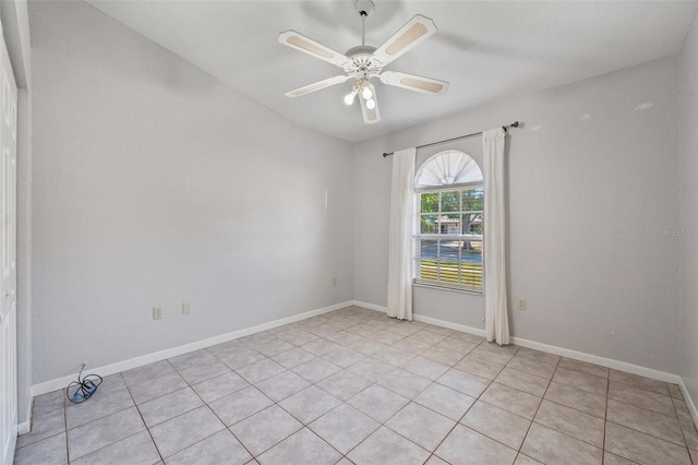 unfurnished room with ceiling fan and light tile patterned flooring