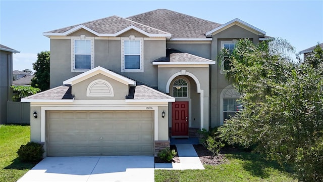 view of front of home with a garage and a front lawn