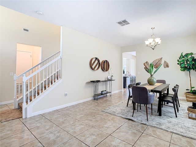 tiled dining space with sink and a chandelier