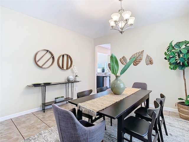 tiled dining area with sink and an inviting chandelier