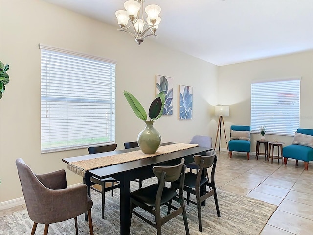 dining room featuring a chandelier and light tile patterned floors